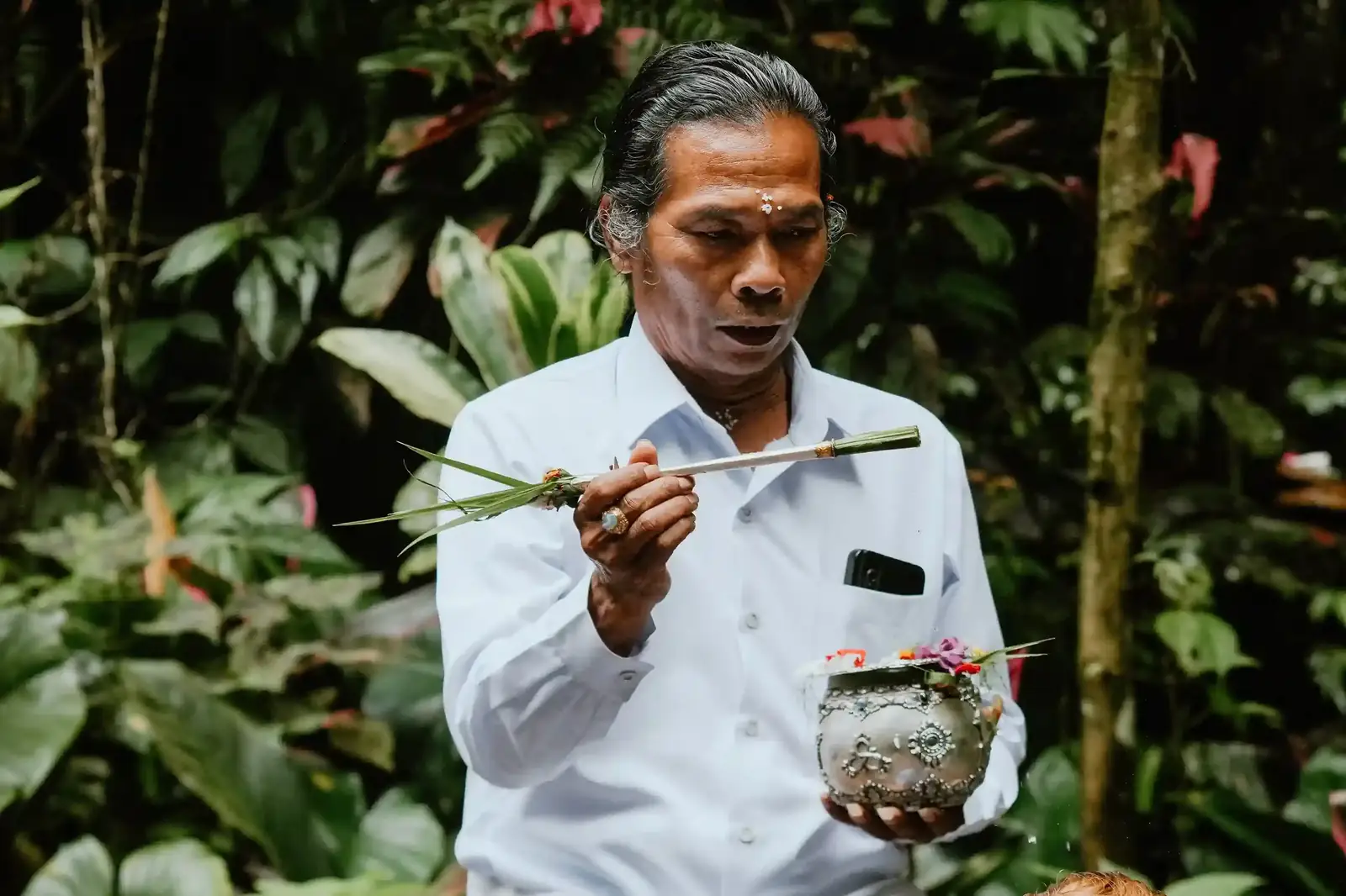 Balinese priest performing a water blessing